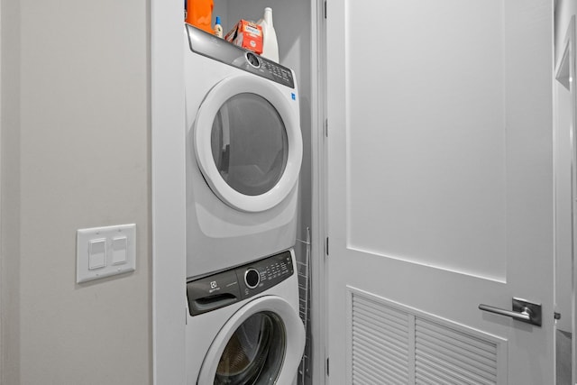 laundry room with stacked washer and dryer