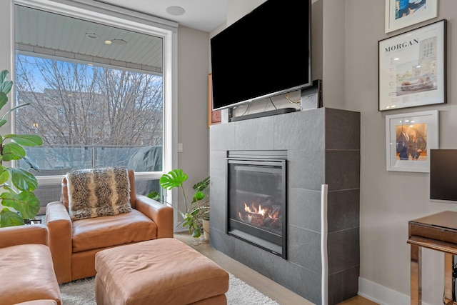 sitting room with a tile fireplace