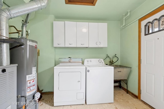 laundry room with washer and clothes dryer, gas water heater, and cabinet space