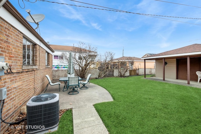 view of yard with a patio area, fence, and central air condition unit