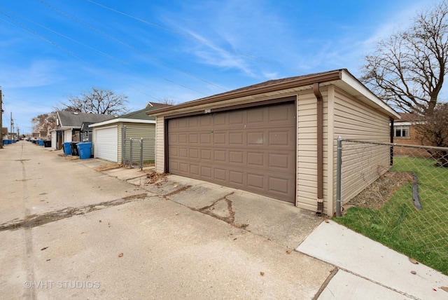 detached garage featuring fence