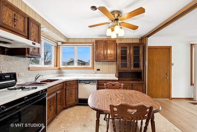 kitchen featuring a sink, dishwasher, light floors, tasteful backsplash, and gas stove