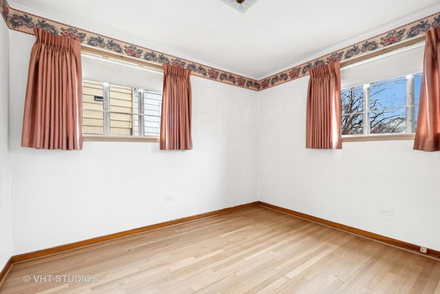 empty room featuring baseboards and wood finished floors