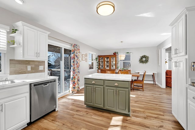 kitchen featuring dishwasher, light hardwood / wood-style floors, and white cabinets