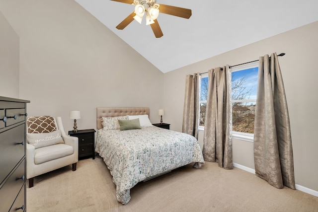 bedroom with ceiling fan, vaulted ceiling, and light carpet