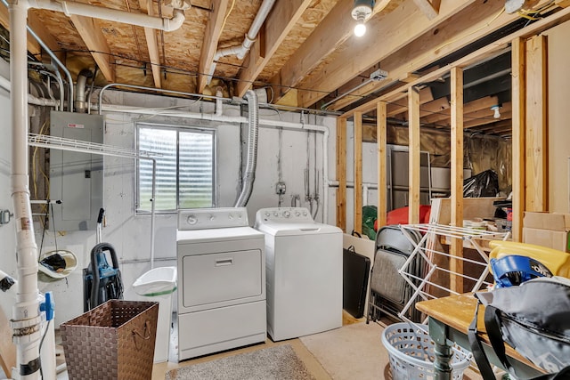 clothes washing area with electric panel and independent washer and dryer