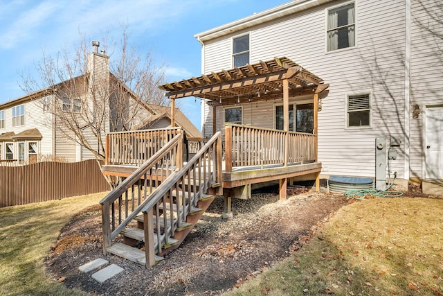 back of house featuring a wooden deck, a lawn, and a pergola