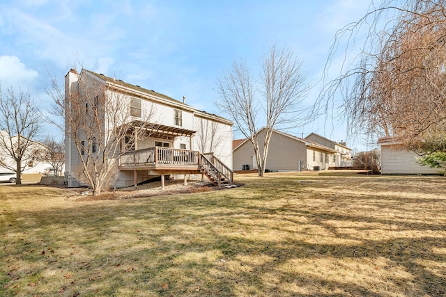 back of house with a yard, a deck, and a pergola