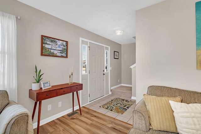 entrance foyer with a healthy amount of sunlight and light hardwood / wood-style flooring