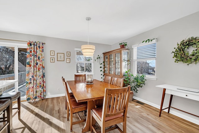 dining space with light hardwood / wood-style floors