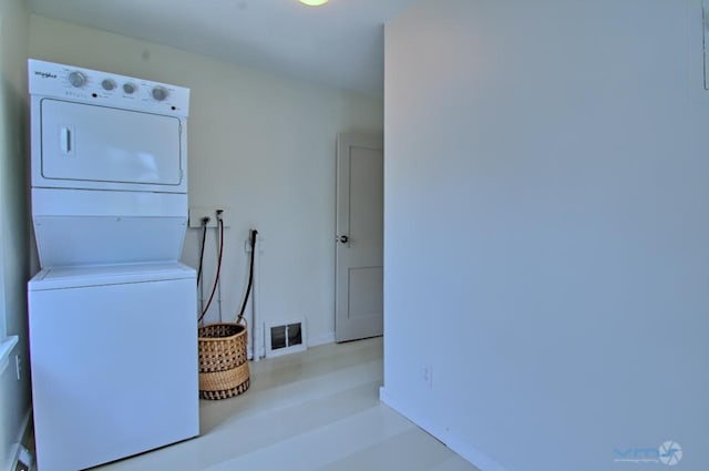 laundry area featuring stacked washer and dryer, laundry area, and visible vents