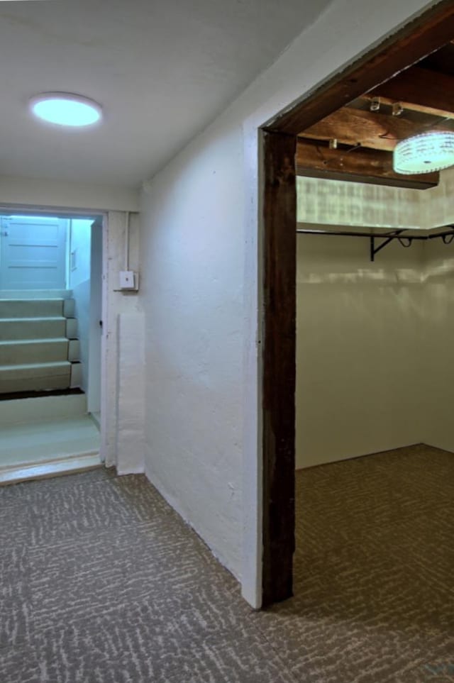 hallway with carpet flooring and stairs