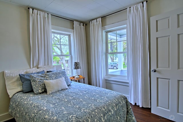 bedroom with dark wood finished floors