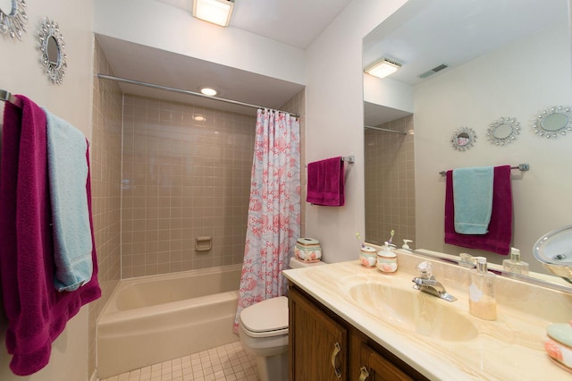 full bathroom featuring tile patterned flooring, vanity, shower / tub combo with curtain, and toilet