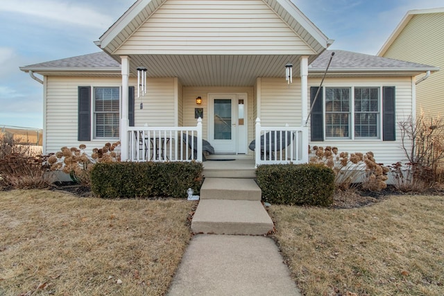 bungalow-style home with a porch and a front lawn