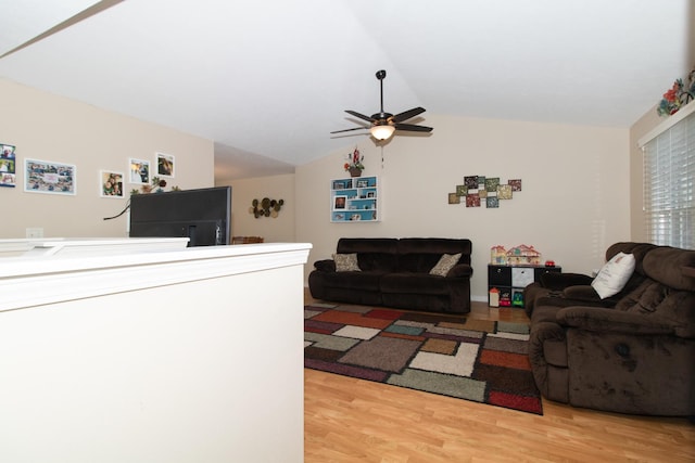 living room with lofted ceiling, ceiling fan, and light hardwood / wood-style flooring