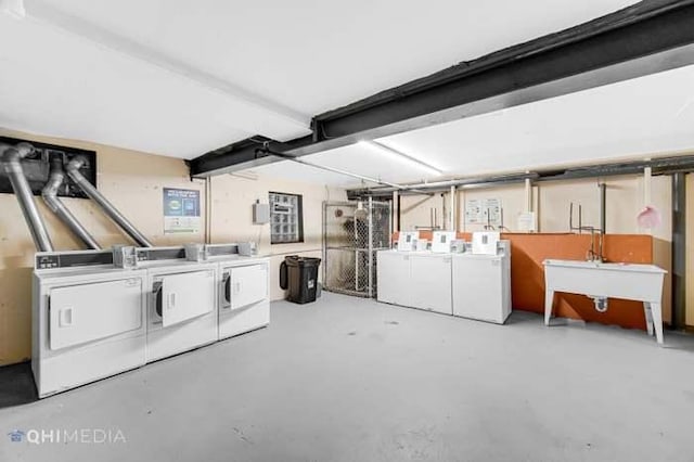 basement with sink and washing machine and dryer