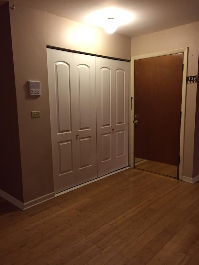 unfurnished bedroom featuring hardwood / wood-style floors and a closet