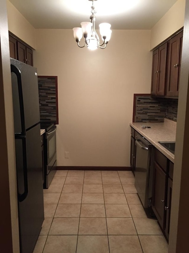 kitchen featuring black refrigerator, tasteful backsplash, stainless steel dishwasher, electric range, and light tile patterned floors