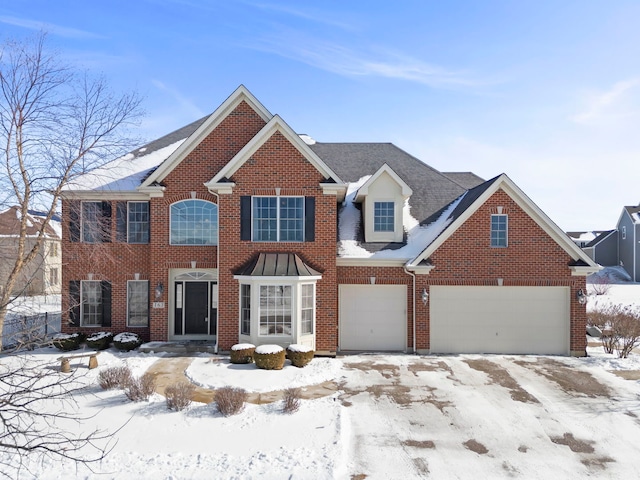 colonial house with a garage and brick siding