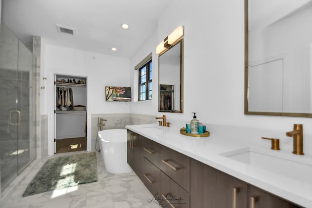 bathroom featuring independent shower and bath and vanity