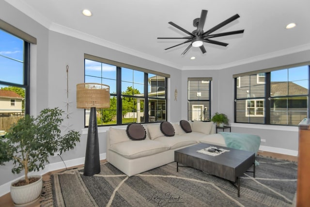 living room with crown molding and ceiling fan