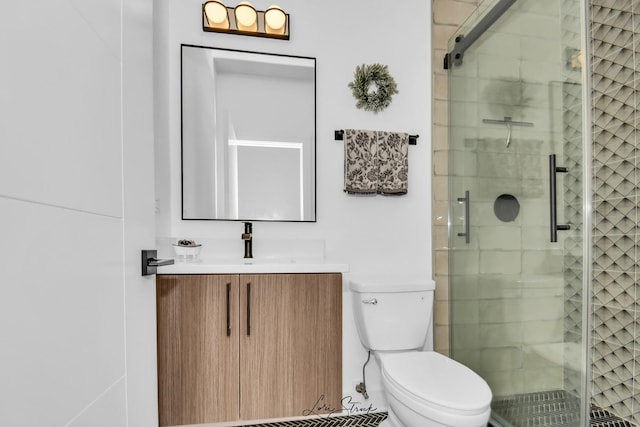 bathroom featuring toilet, vanity, and walk in shower