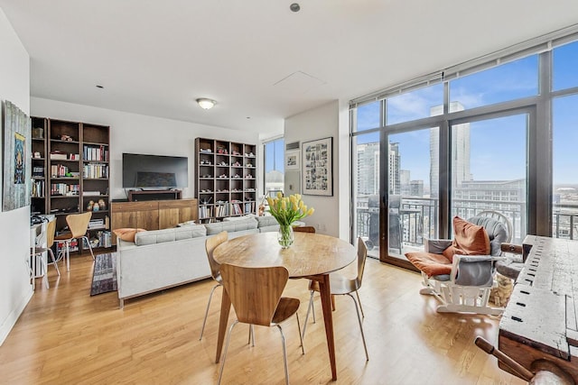 dining area with expansive windows and light wood finished floors