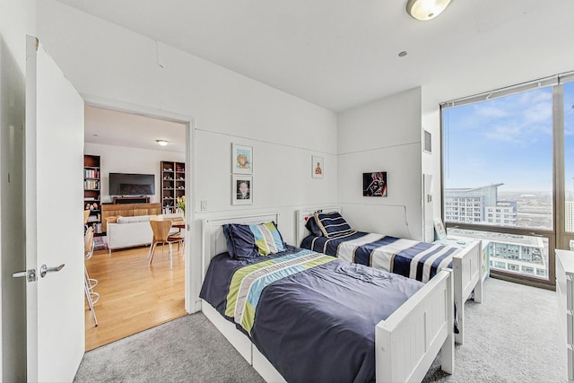 bedroom featuring carpet, visible vents, and a city view