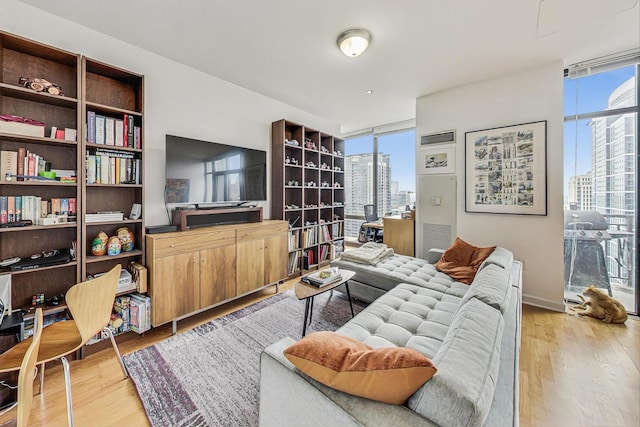 living area featuring light wood-type flooring and floor to ceiling windows