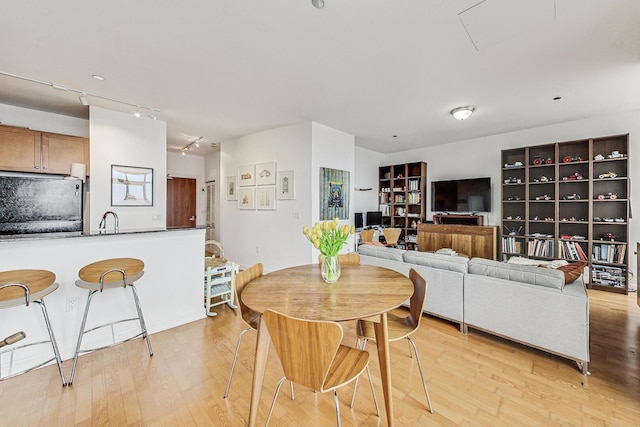 dining space featuring light wood-type flooring