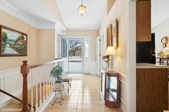 doorway featuring vaulted ceiling and light tile patterned flooring