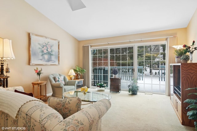 carpeted living room with vaulted ceiling