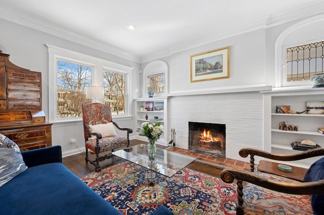 living room with crown molding, a fireplace, and dark hardwood / wood-style floors