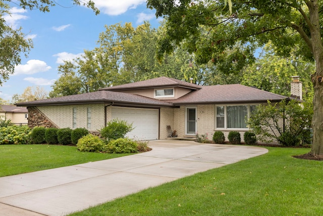 view of front of property with a garage and a front lawn