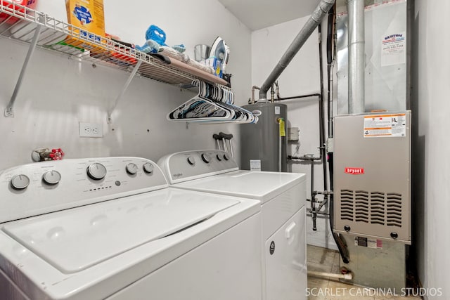 laundry room featuring washer and clothes dryer, heating unit, and gas water heater