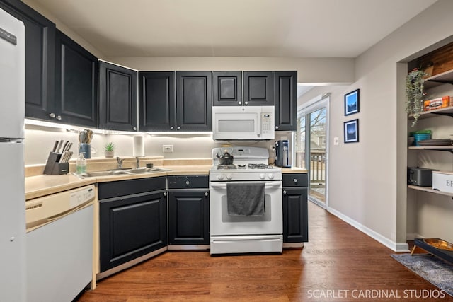 kitchen with dark hardwood / wood-style flooring, sink, and white appliances