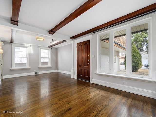 entryway with dark hardwood / wood-style flooring and beam ceiling