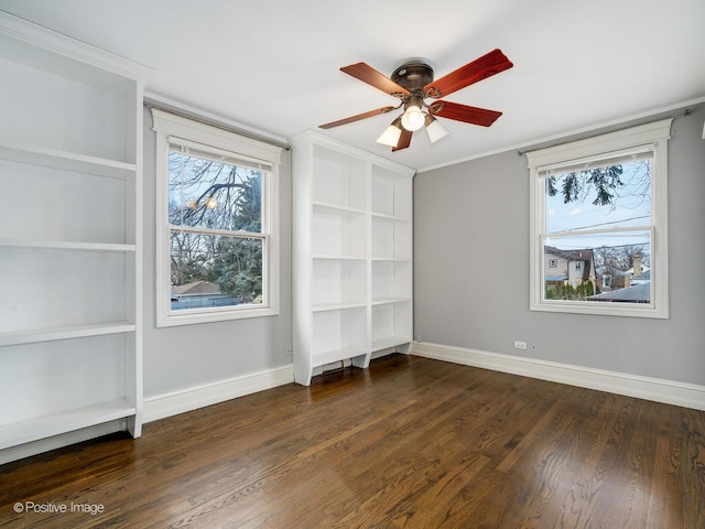 spare room featuring ceiling fan, ornamental molding, and dark hardwood / wood-style flooring