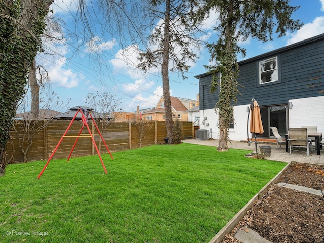 view of yard featuring central AC unit and a patio area