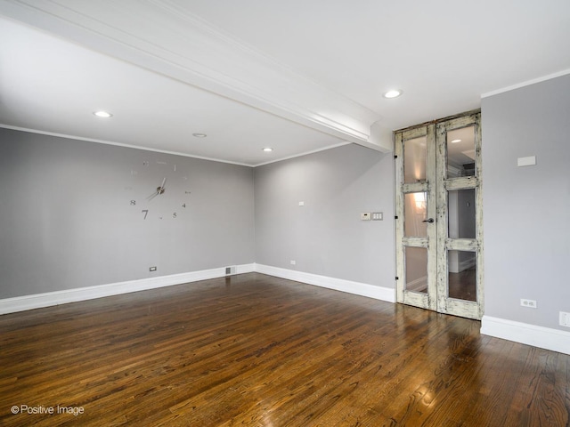 empty room with crown molding and dark hardwood / wood-style flooring