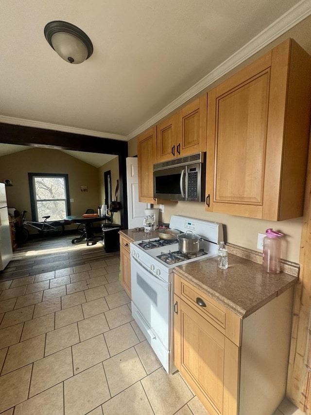 kitchen featuring crown molding and white gas stove