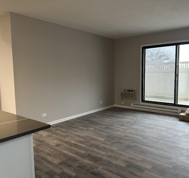 empty room featuring dark wood-type flooring and a wall mounted AC