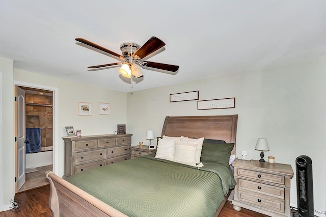 bedroom with dark hardwood / wood-style flooring, connected bathroom, and ceiling fan