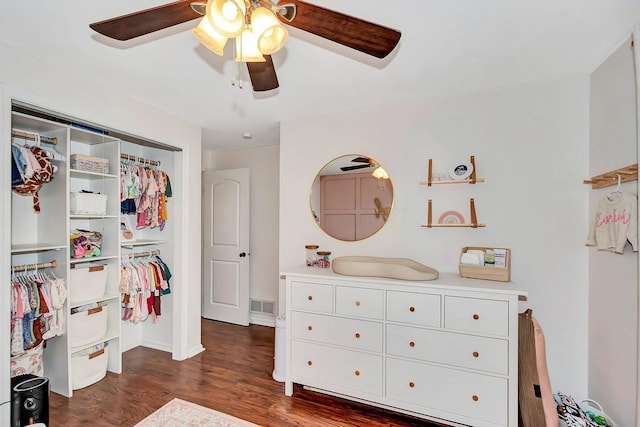 bedroom with ceiling fan, dark hardwood / wood-style floors, and a closet