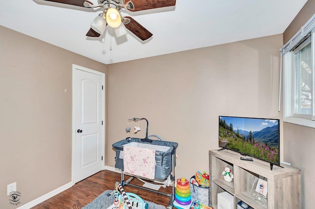 interior space with dark hardwood / wood-style flooring and ceiling fan