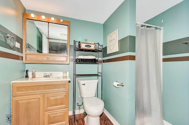 bathroom with vanity, toilet, a shower with shower curtain, and hardwood / wood-style floors