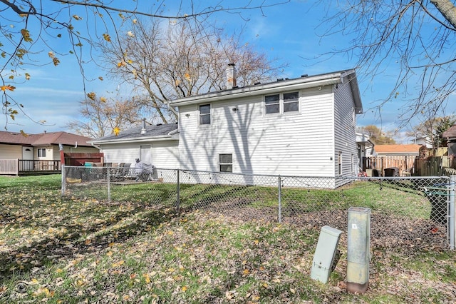 rear view of house featuring a yard