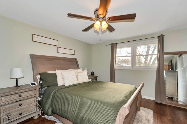 bedroom with dark hardwood / wood-style floors and ceiling fan