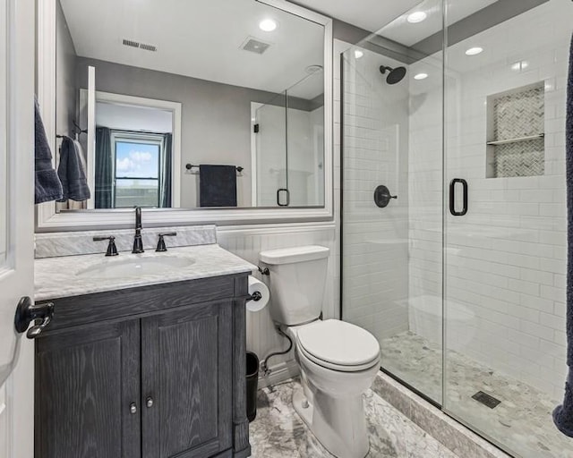 full bathroom with toilet, a shower stall, visible vents, and vanity